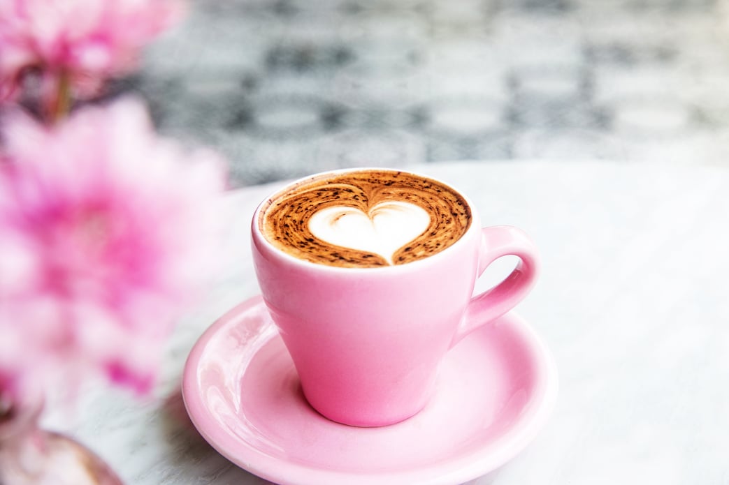 Pink Cup of hot latte coffee on marble table background