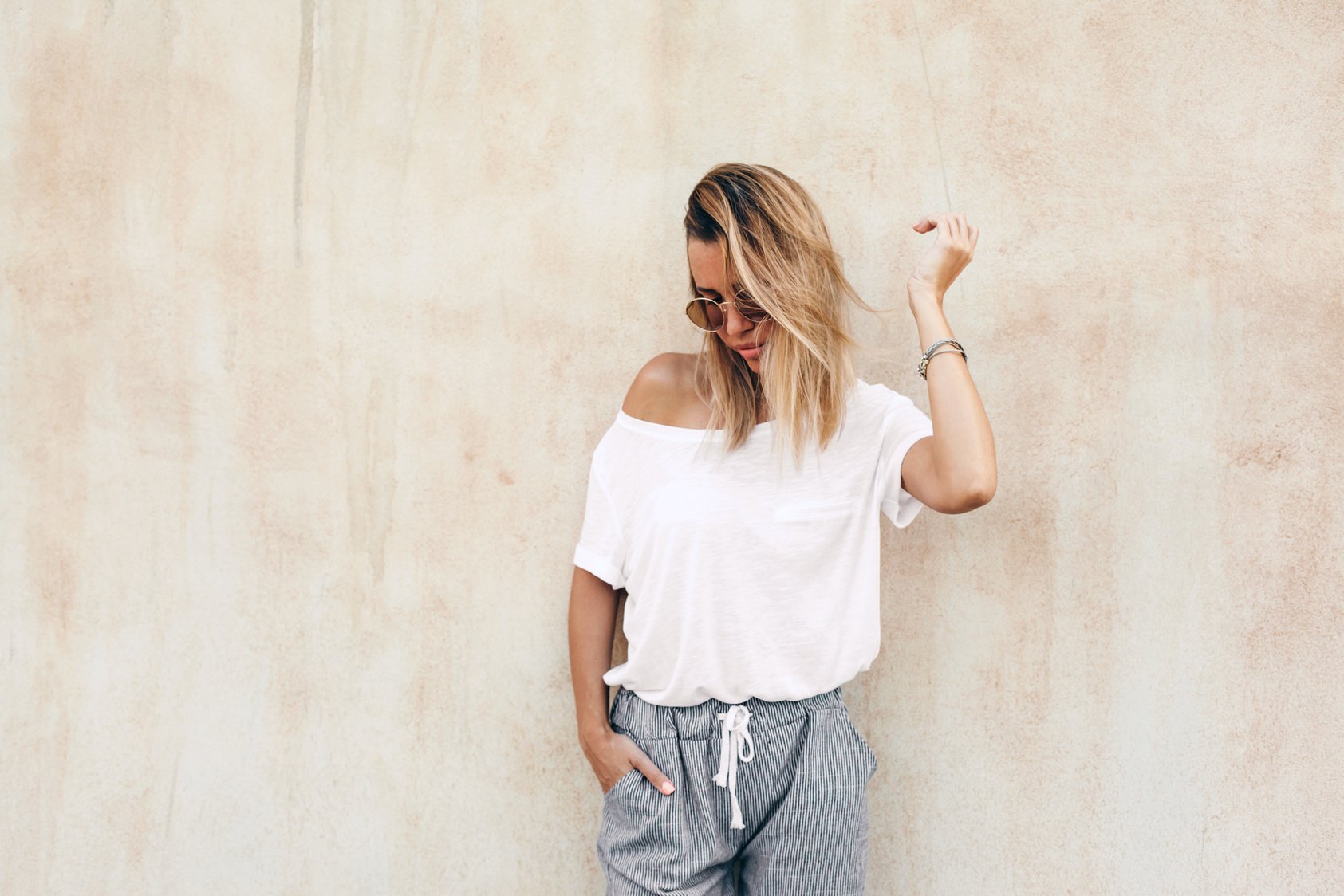 Woman in White T-Shirt on Beige Background